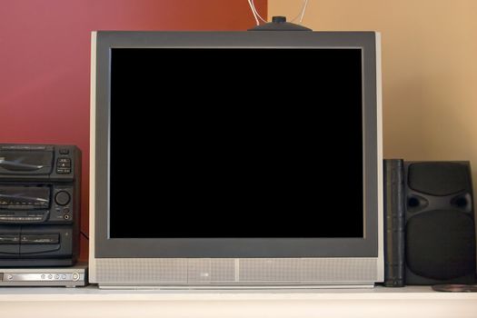 A modern picture tube tv set - 32 inch.  Standard aspect ratio, non-widescreen.  Also in the shot is a set top antenna, stereo, and dvd player.  Included clipping path for the screen.