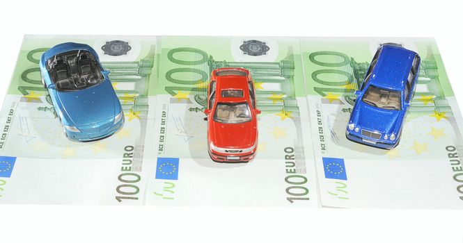 Three Toy Cars On One Hundred Euro Bills.