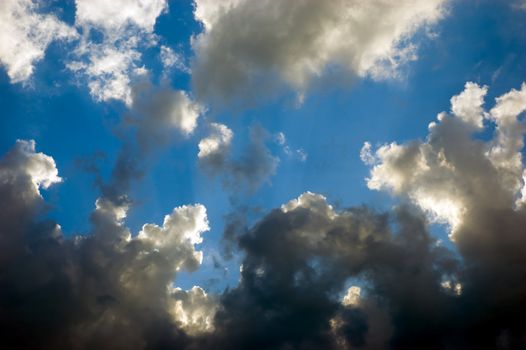 dramatic sky with black and white clouds over deep blue