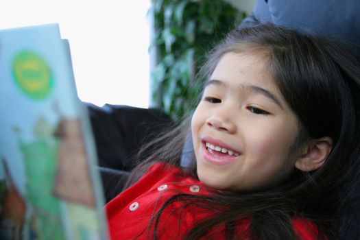 Child happily reading a book