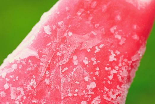 Sample crystals. Red Ice cream on a green background