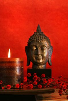 Asian theme with candle and buddha head