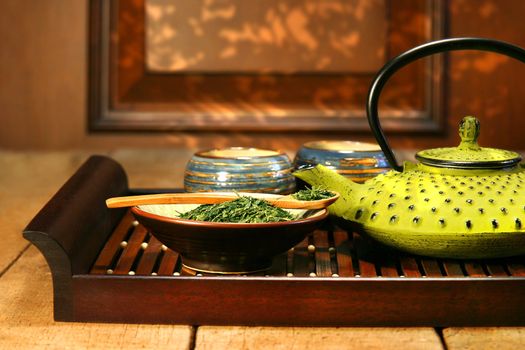 Cast iron teapot ready to make a warm cup of green tea