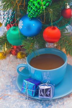 Holiday- cup of tea stands under the Christmas tree