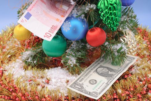 Banknotes euro and dollar are under the Christmas tree