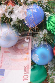 Banknotes euro are under the Christmas tree