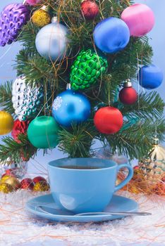 Holiday- cup of tea stands under the Christmas tree