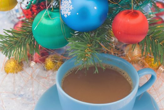 Holiday- cup of tea stands under the Christmas tree