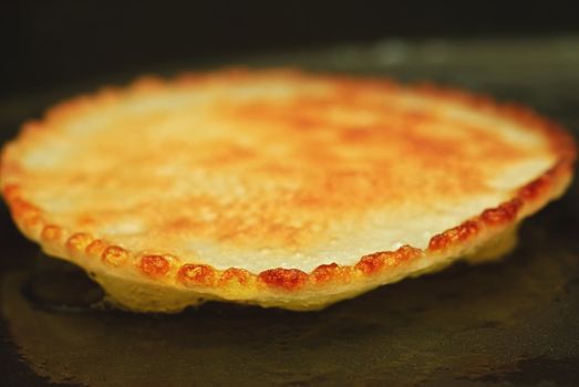 Cooking pancakes in a pan. Traditional food