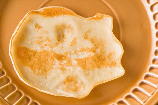 pancake rests on a plate ready for breakfast