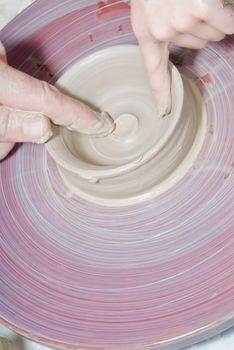 Potter's wheel. Making dishes from clay