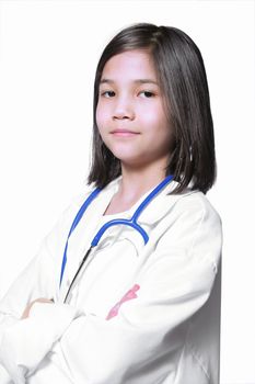 Nine year old girl playing doctor with white lab coat and stethoscope