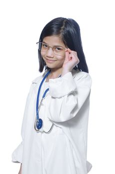 Nine year old girl playing doctor with white lab coat and stethoscope