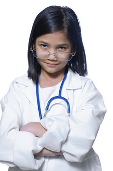 Nine year old girl playing doctor with white lab coat and stethoscope