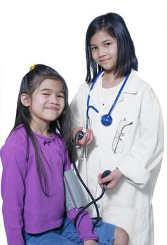Two girls playing doctor and patient