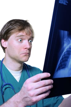 Male doctor looking with humorous shock at x ray