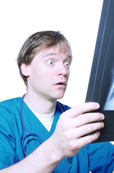 Male doctor looking with humorous shock at x ray