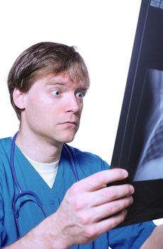 Male doctor looking with humorous shock at x ray