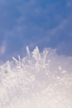Ice crystals on a background of blue sky