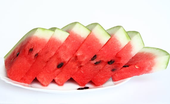 Slices of juicy watermelon served on white plate isolated on white background