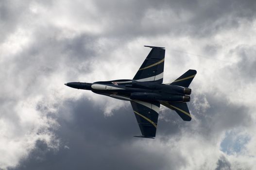 Fighter Jet plane against storm clouds