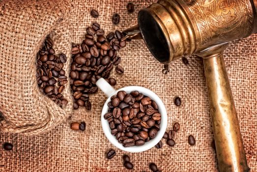 Arabic old copper turks, cup with grains and  scattered coffee grains