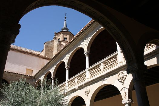 Beautiful courtyard garden and decorative cloisters at vintage Museo de la Santa Cruz - museum in Toledo, Spain