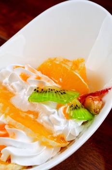 Ice cream dessert with kiwi, strawberry and orange