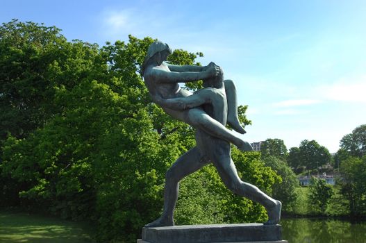 OSLO, NORWAY - May 28: sculpture of a man holding a girl who resists in Vigeland park in Oslo, Norway on May 28, 2008. installed in the park 212 bronze and granite sculptures created by Gustav Vigeland.