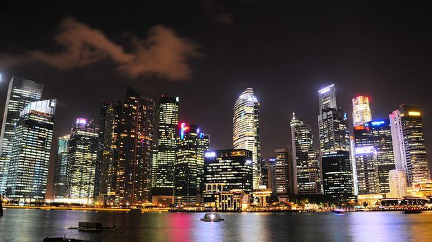  Singapore - March 05, 2013:  Night panorama of Singapore downtown. There are more than 7,000 multinational corporations from United States, Japan and Europe in Singapore. 