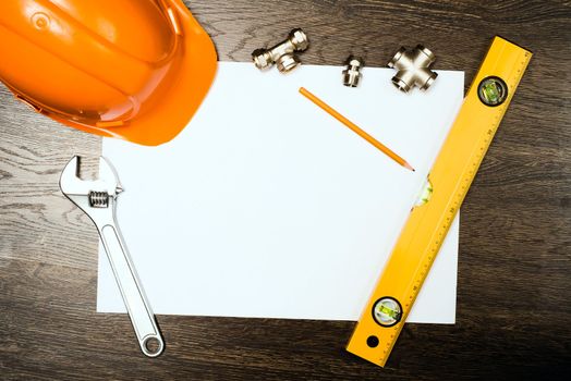 plumbing tools on a white sheet of paper, place for text