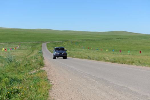 SUV moving in Hulun Buir grassland of Inner-Mongolia, China