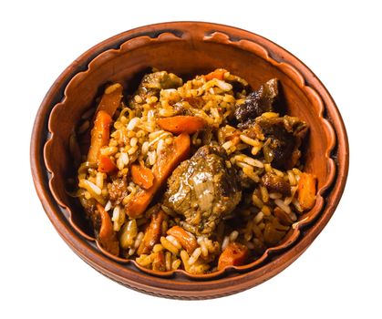 East pilaf with rice and meat in a ceramic cauldron