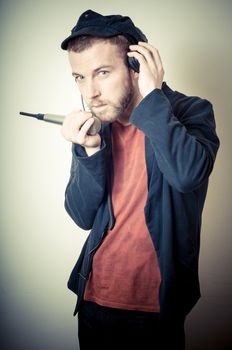 vintage portrait of fashion guy with headphones on gray background