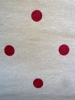 red spots on white fabric as a background