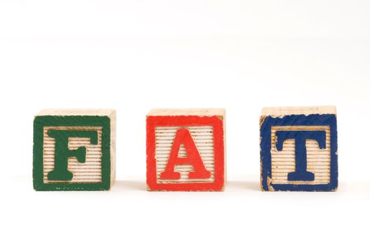 Children wooden blocks spelling the word "Fat"