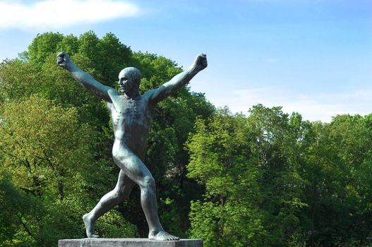 sculpture of a man with his hands up in the Vigeland park, Oslo