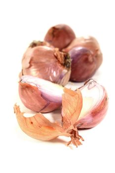Shallots and peel on a white background