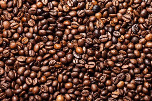 Brown roasted raw coffee bean heap background