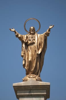 Statue of Jesus Christ on the deep blue sky background with copy space