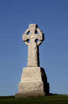 Morning light on a stone Celtic Cross with copy space in the sky