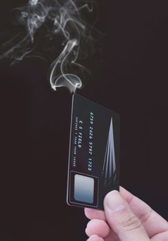 Smoke rising from burning credit card