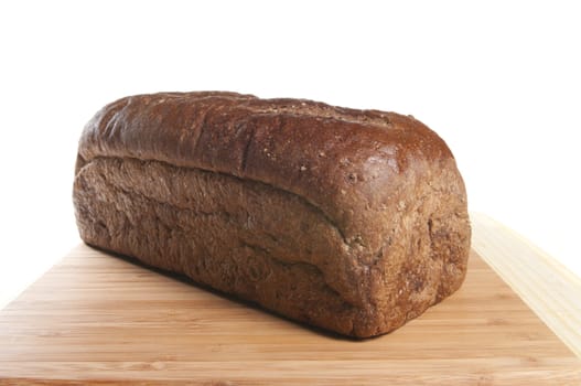 Freshly baked whole wheat bread cooling on the cutting board