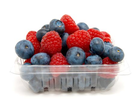 Basket with a raspberry and a blueberry on a white background   