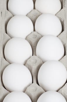 Selective focus on the middle eggs in the carton