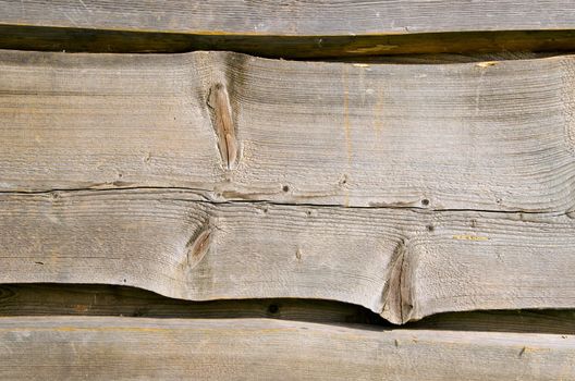 Wooden village house walls carved planks closeup background.