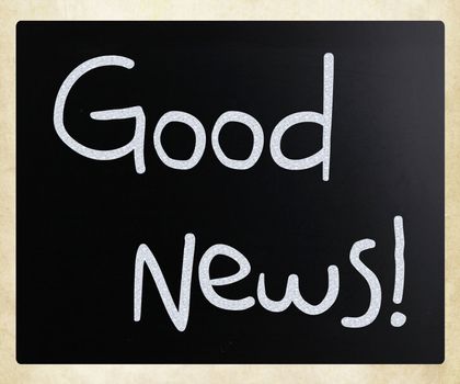 "Good News!" handwritten with white chalk on a blackboard