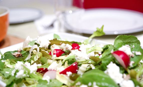 A healty and tastefully mixed salad with feta cheese
