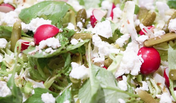 A healty and tastefully mixed salad with feta cheese