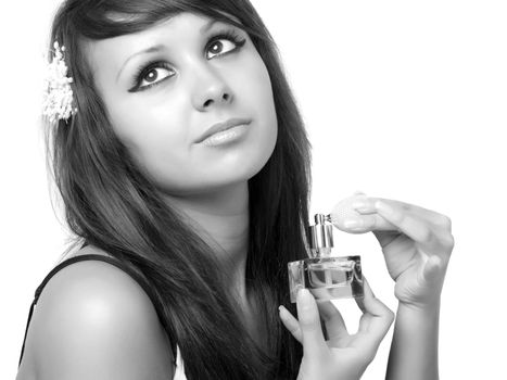 Young woman applying perfume on her neck.